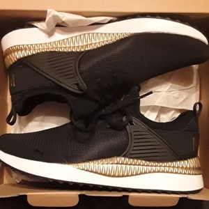 Black, Gold, and White Puma Shoes